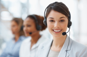 Closeup of a cute business woman with headset at workplace